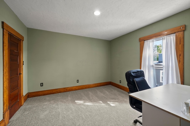 office space featuring a textured ceiling, baseboards, recessed lighting, and carpet