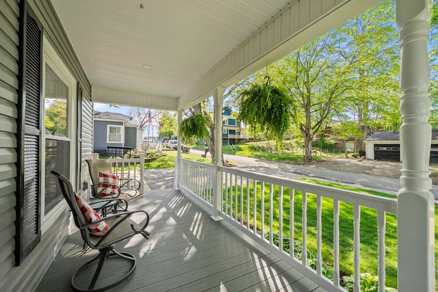 wooden deck with covered porch and a residential view