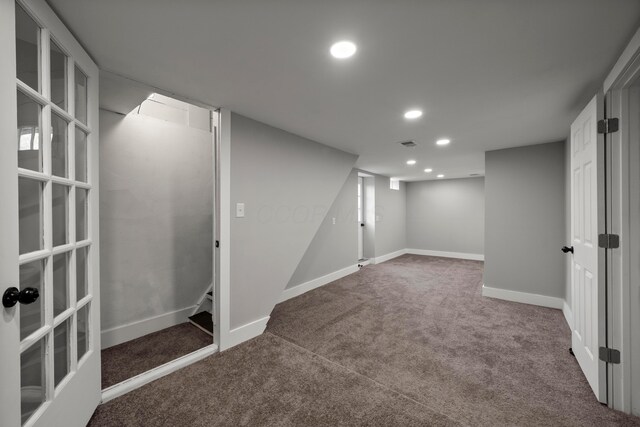 finished below grade area featuring carpet floors, recessed lighting, baseboards, and visible vents