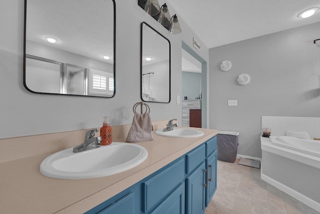4441 Butler Farms Dr, Columbus, OH 43207 - full bath featuring double vanity, a garden tub, baseboards, and a shower with door