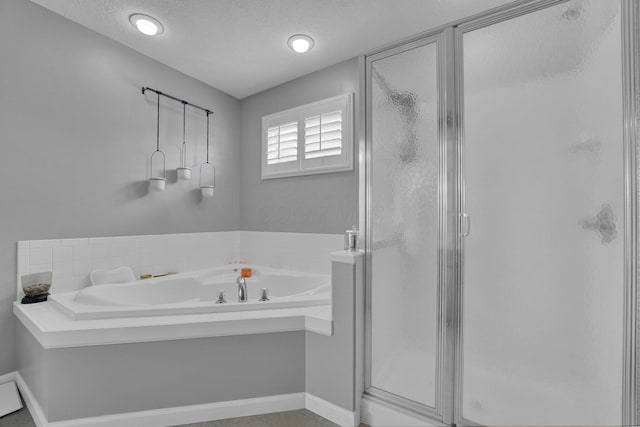 4441 Butler Farms Dr, Columbus, OH 43207 - bathroom with a stall shower, a garden tub, a textured ceiling, and baseboards