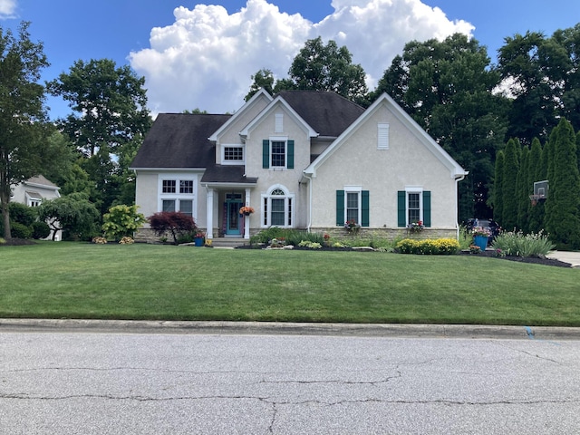 view of front of property with a front yard and stucco siding