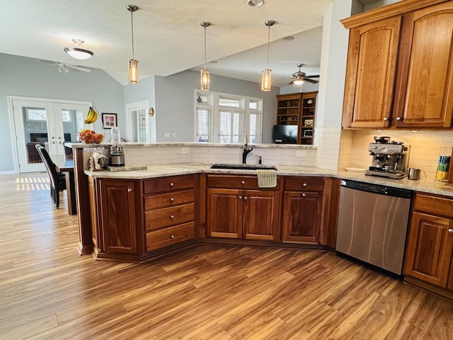 kitchen with ceiling fan, a sink, dishwasher, french doors, and light wood-type flooring