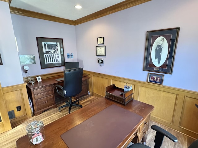 office area with a wainscoted wall, ornamental molding, a decorative wall, and wood finished floors