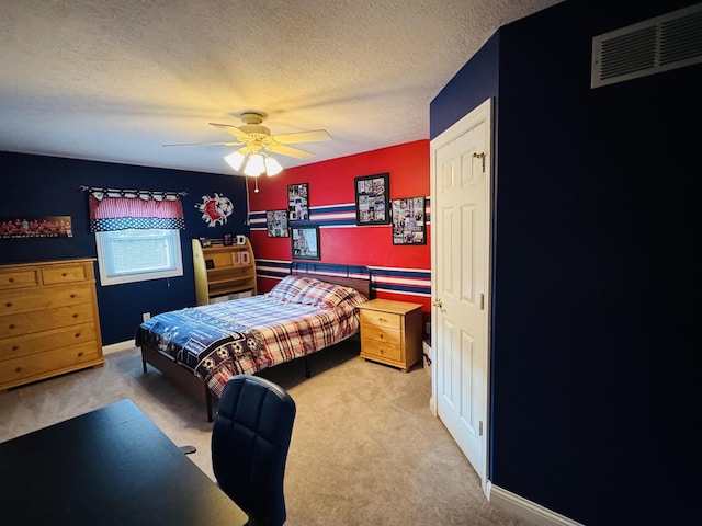 carpeted bedroom with a ceiling fan, a textured ceiling, and visible vents