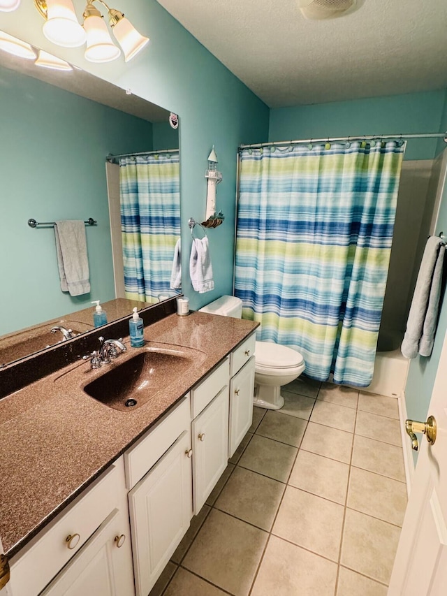 full bathroom with vanity, toilet, a shower with shower curtain, a textured ceiling, and tile patterned floors