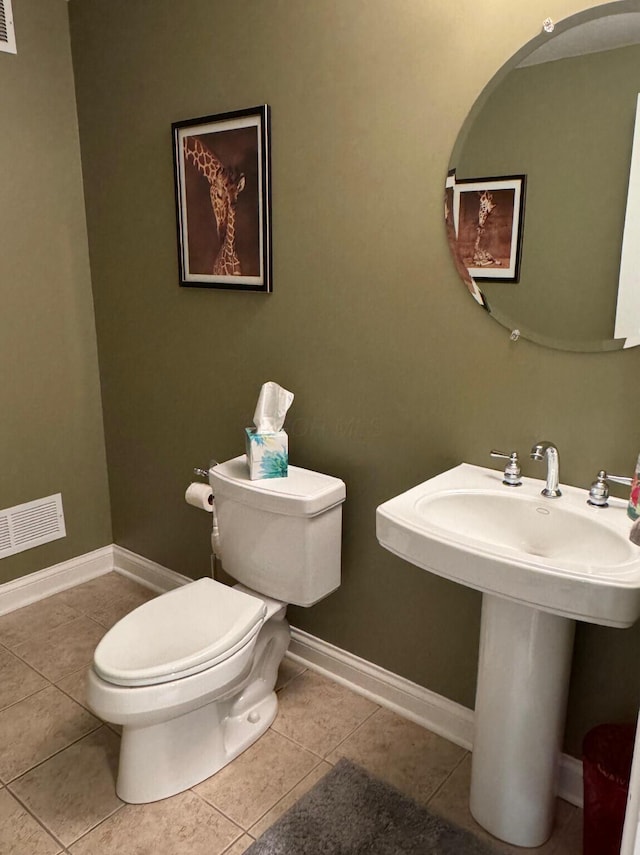 half bathroom featuring baseboards, tile patterned flooring, toilet, and visible vents