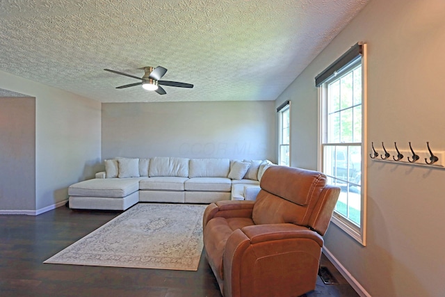 living room featuring plenty of natural light, a textured ceiling, ceiling fan, and wood finished floors