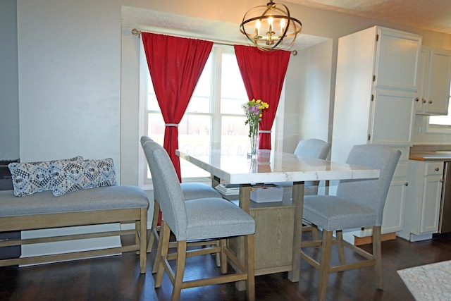 dining area featuring an inviting chandelier and dark wood-style floors