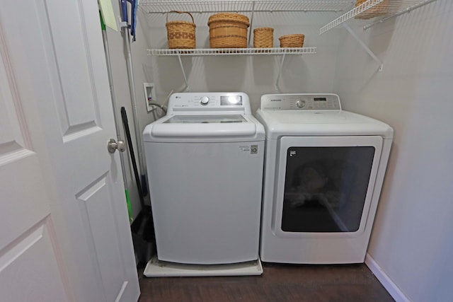 laundry room with laundry area, washer and clothes dryer, baseboards, and dark wood-style floors