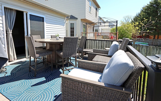 wooden deck featuring fence, outdoor dining space, and an outdoor hangout area