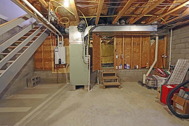 unfinished basement featuring heating unit, stairs, and water heater