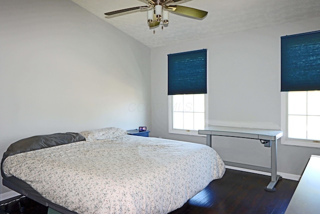 bedroom with baseboards, dark wood finished floors, and ceiling fan