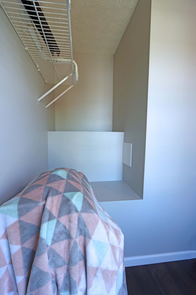 unfurnished bedroom with baseboards and wood finished floors