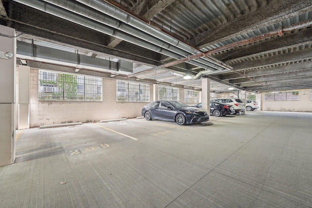 parking garage featuring concrete block wall