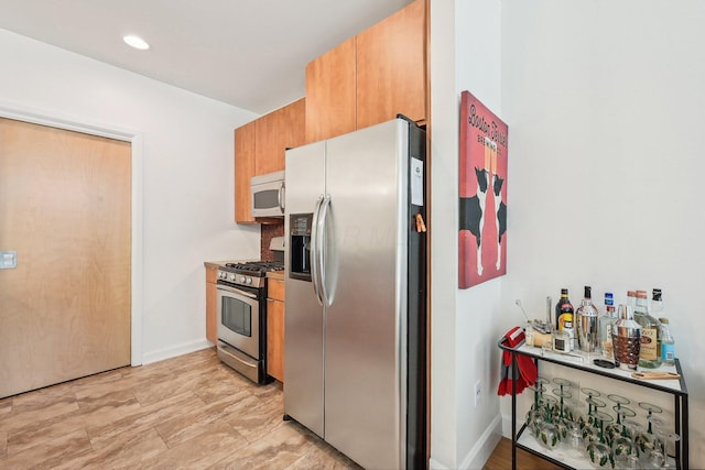 kitchen featuring recessed lighting, baseboards, and appliances with stainless steel finishes