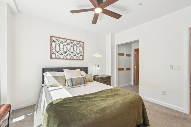 bedroom with baseboards, a ceiling fan, and light colored carpet
