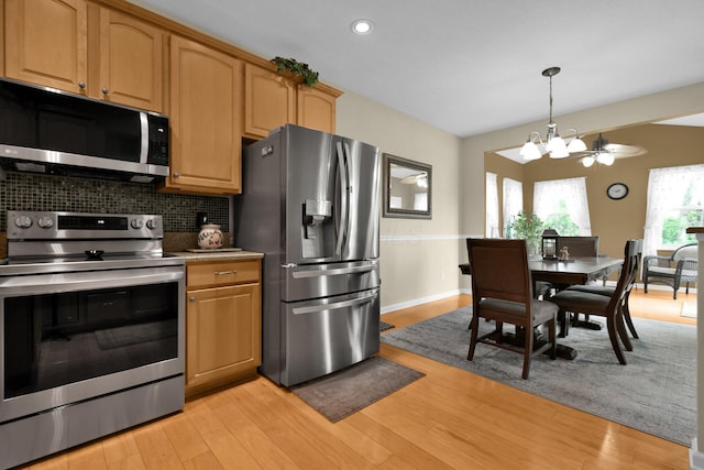 5914 Grant Run Estates Dr, Grove City, OH 43123 - kitchen featuring tasteful backsplash, stainless steel appliances, light wood finished floors, and a notable chandelier