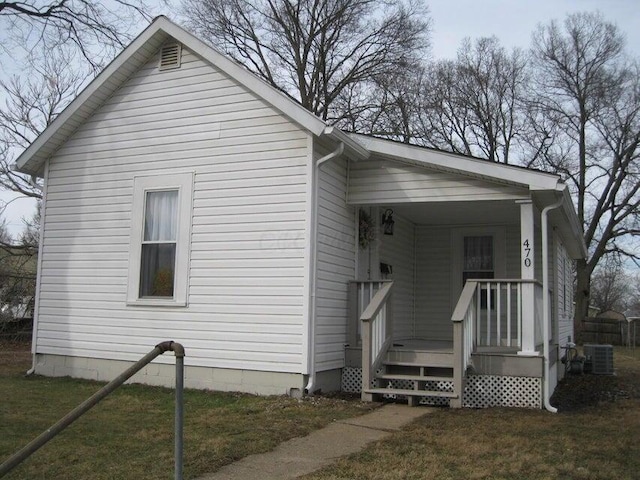 view of side of property with covered porch and central AC