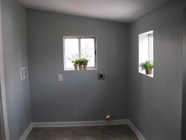 spare room featuring baseboards