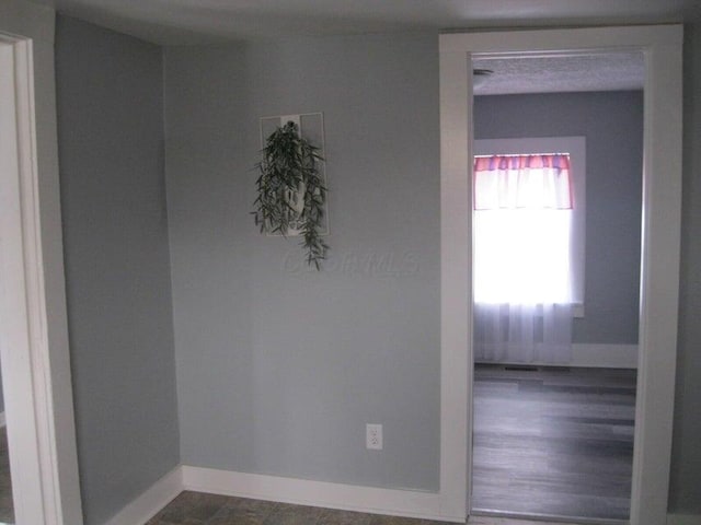 spare room with baseboards
