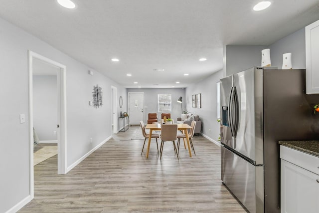 dining room with recessed lighting, baseboards, and light wood finished floors