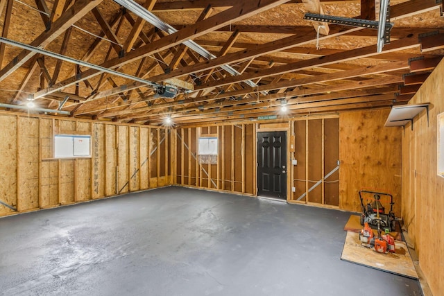 interior space with a garage and unfinished concrete flooring
