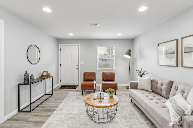 living area with baseboards, recessed lighting, wood finished floors, and visible vents