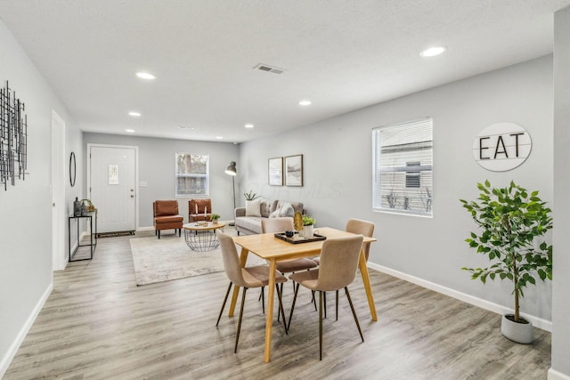 dining room with recessed lighting, baseboards, visible vents, and light wood-type flooring