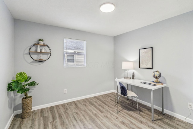 home office featuring baseboards and light wood-style flooring