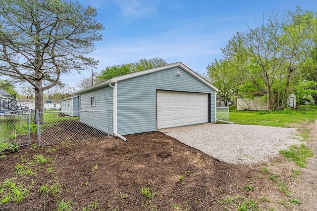 detached garage featuring fence