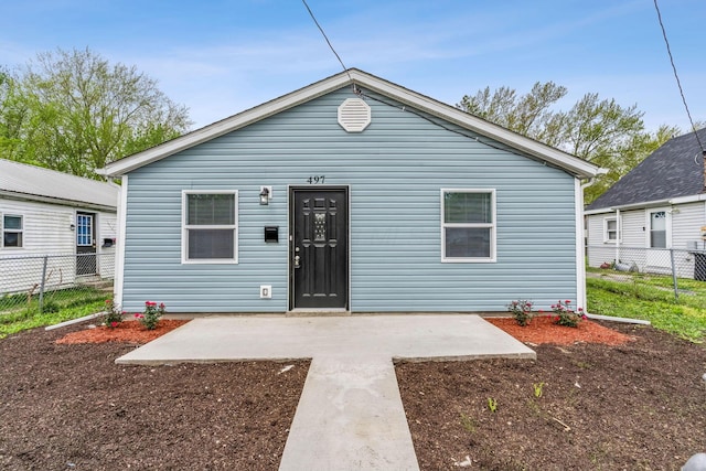 view of front of property with a patio area and fence