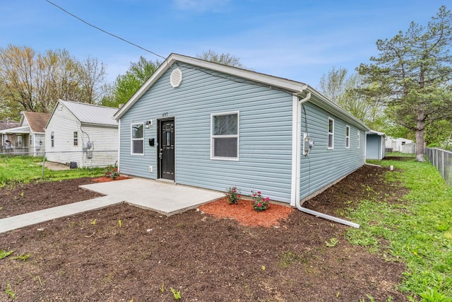 view of front of home featuring a patio area and fence