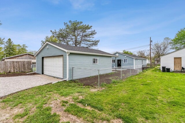 detached garage with fence and driveway