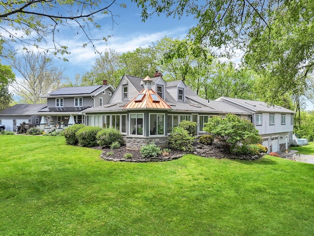 1108 W Church St, Newark, OH 43055 - view of front of property with a front yard, a chimney, stone siding, and a garage