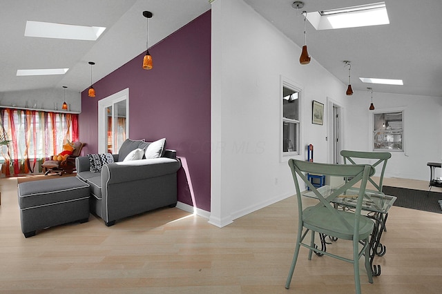 1108 W Church St, Newark, OH 43055 - living area with a skylight, lofted ceiling, wood finished floors, and baseboards