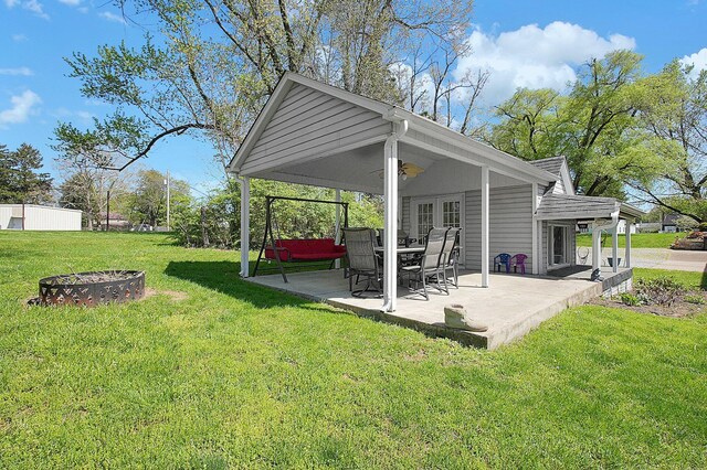 1108 W Church St, Newark, OH 43055 - view of green lawn with a fire pit, a patio, and a ceiling fan