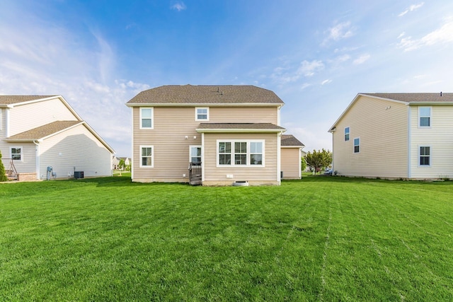 rear view of house featuring a lawn