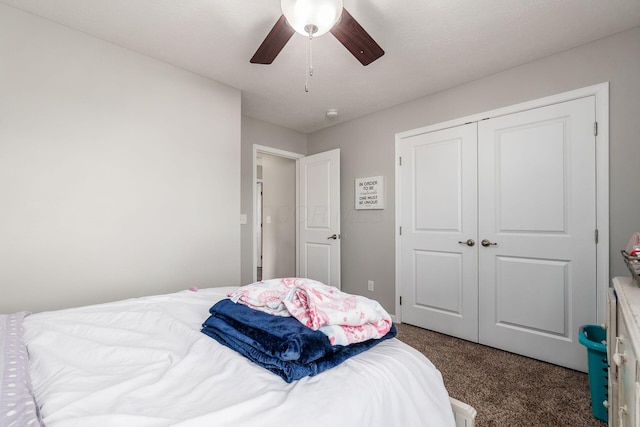 carpeted bedroom featuring a closet and ceiling fan