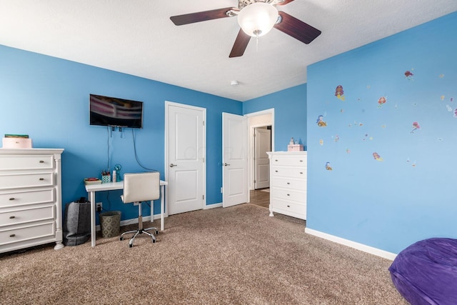 carpeted office with baseboards and ceiling fan