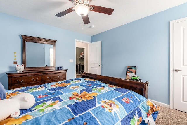 carpeted bedroom featuring baseboards and a ceiling fan