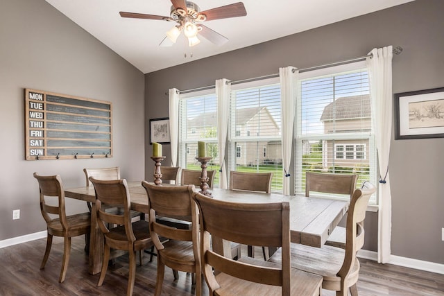 dining area featuring baseboards, ceiling fan, wood finished floors, and lofted ceiling