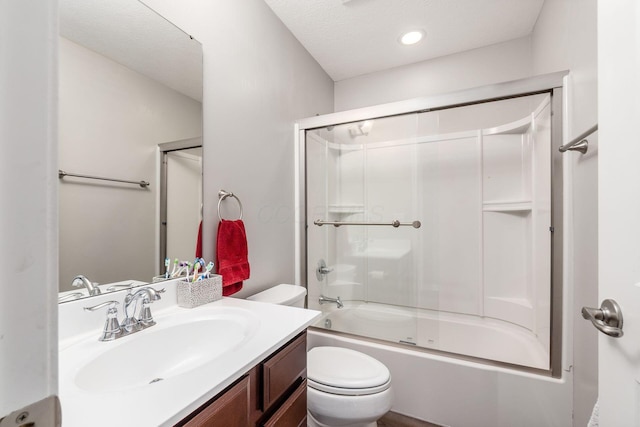 bathroom with toilet, shower / bath combination with glass door, and vanity