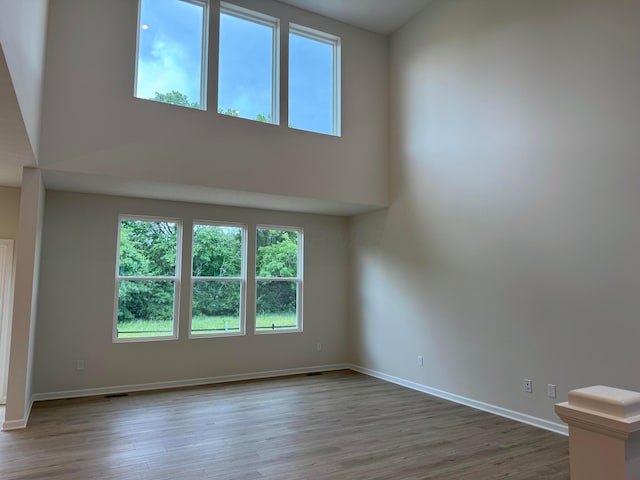 9920 Glenfield Ct Lot 51, Plain City, OH 43064 - unfurnished room with wood finished floors and a towering ceiling