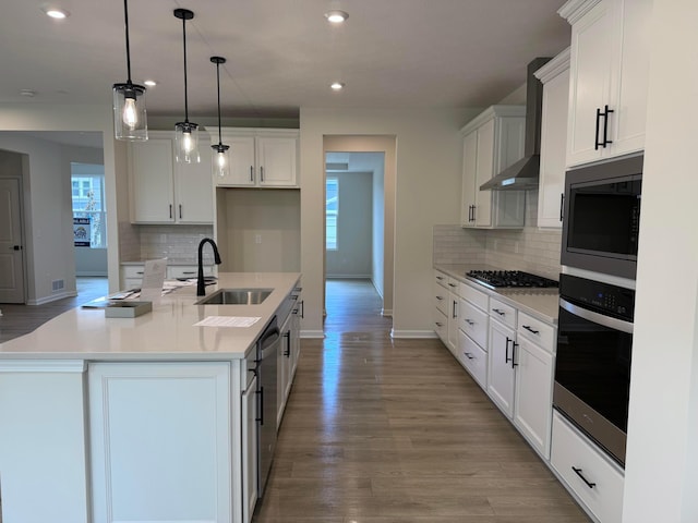 9920 Glenfield Ct Lot 51, Plain City, OH 43064 - kitchen featuring appliances with stainless steel finishes, wall chimney exhaust hood, recessed lighting, light wood-type flooring, and tasteful backsplash