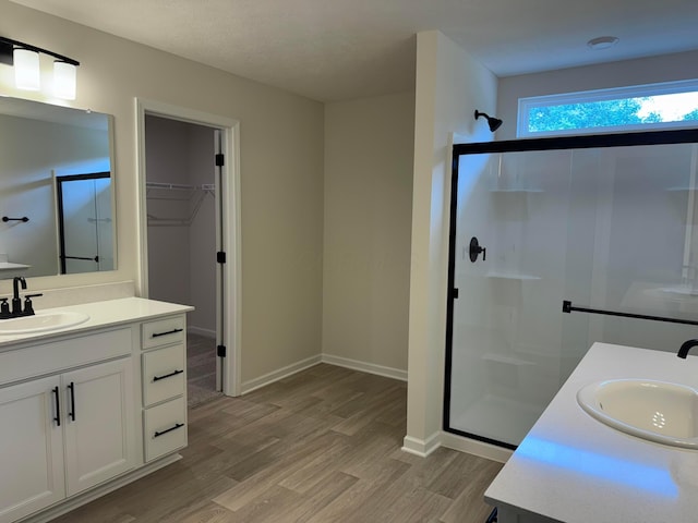 9920 Glenfield Ct Lot 51, Plain City, OH 43064 - bathroom with a shower stall, two vanities, wood finished floors, and a walk in closet