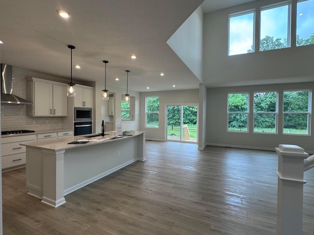 9920 Glenfield Ct Lot 51, Plain City, OH 43064 - kitchen featuring wall chimney range hood, stainless steel microwave, stovetop, recessed lighting, and black oven