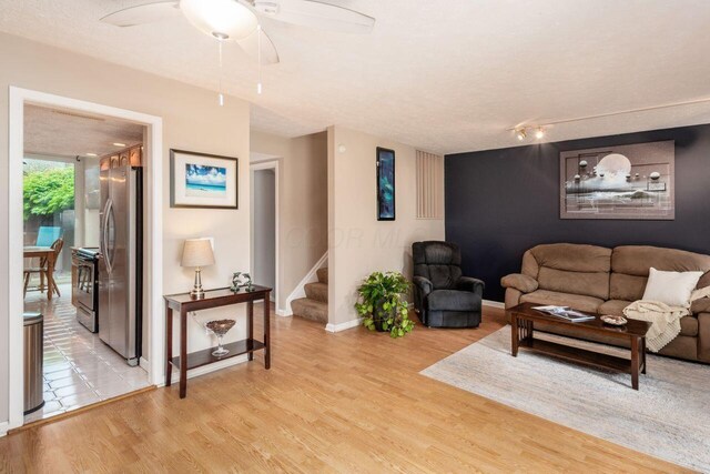 4917 Whistlewood Ln Unit 5, Westerville, OH 43081 - living area with stairway, baseboards, a ceiling fan, and light wood-style flooring