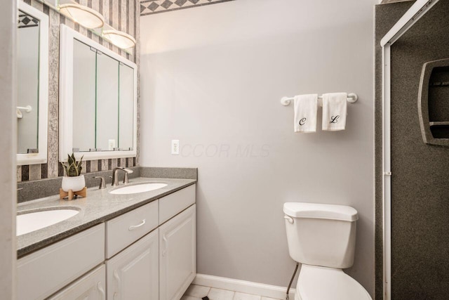 4917 Whistlewood Ln Unit 5, Westerville, OH 43081 - bathroom featuring a sink, baseboards, toilet, and double vanity