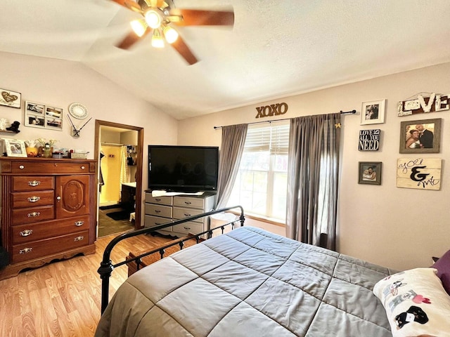 bedroom featuring ceiling fan, lofted ceiling, and light wood finished floors